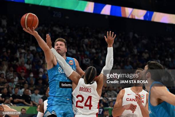 Slovenia's Luka Doncic and Canada's Dillon Brooks vie for the ball during the FIBA Basketball World Cup quarter-final match between Canada and...