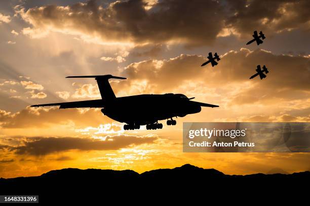 drone attack on transport aircraft in the sky - military drones flying fotografías e imágenes de stock