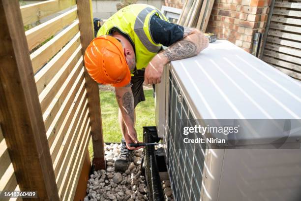 heat pump maintenance - laying stock pictures, royalty-free photos & images