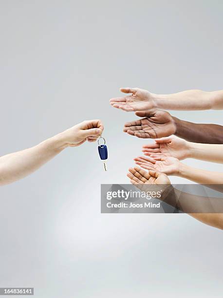 hand holding car key, multiple hands receiving - sharing economy stock pictures, royalty-free photos & images