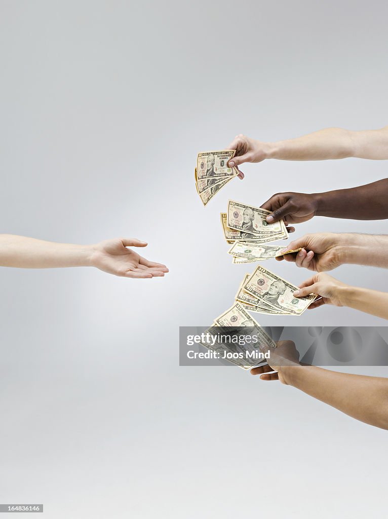 Hands holding out money, one hand receiving