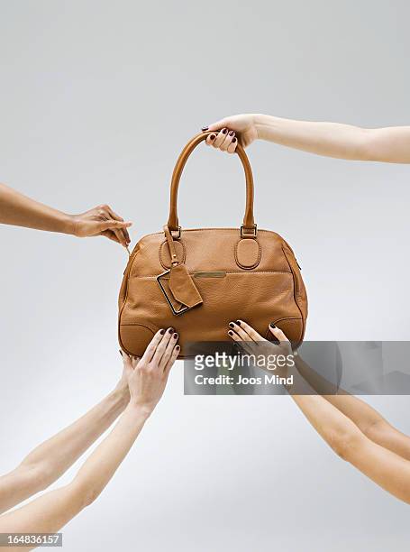 female hands holding a handbag - handtasche stock-fotos und bilder