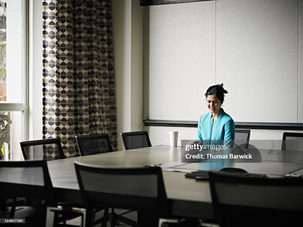 Businesswoman working on digital tablet in office