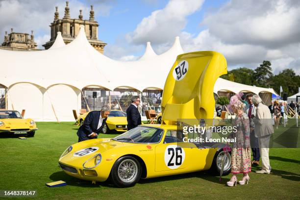 Visitors inspect a 1965 Ferrari 250 LM during the Salon Prive classic car event at Blenheim Palace on August 30, 2023 in Woodstock, England. The...
