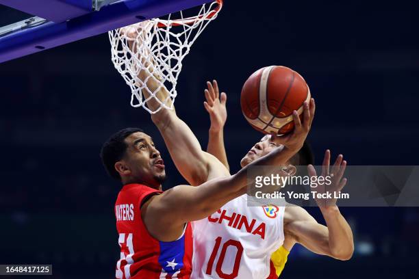 Tremont Waters of Puerto Rico drives to the basket against Zhou Peng of China in the first quarter during the FIBA Basketball World Cup Group B game...