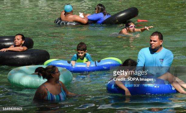 People on swimming rings enjoy floating at Rock Springs Kelly Park in Apopka on Labor Day.