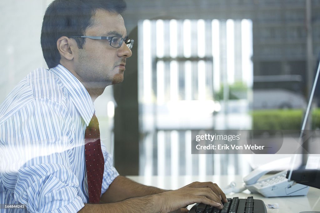 Man working on computer in lg modern office space