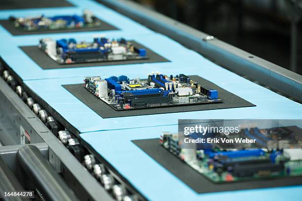 motherboards on conveyor in manufacturing facility - computer part imagens e fotografias de stock