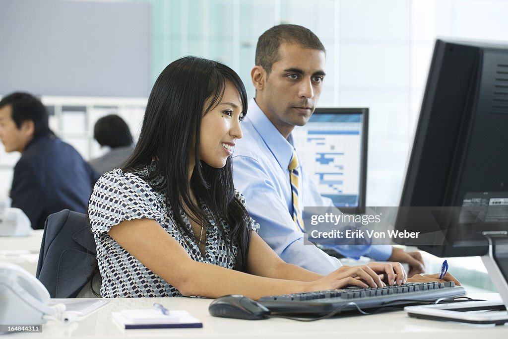 Woman and man working in large open modern office