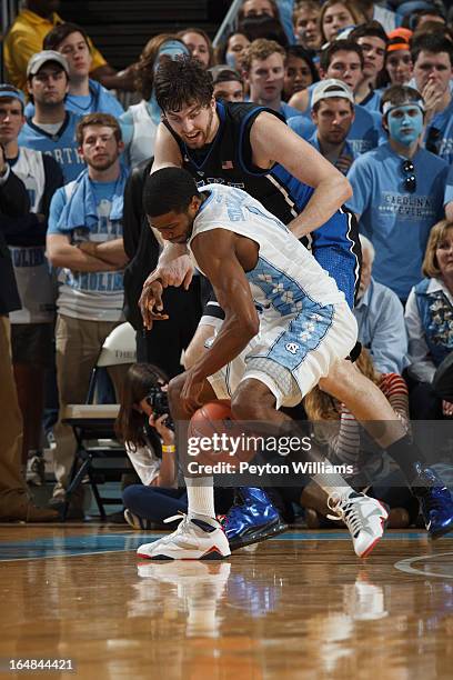 Dexter Strickland of the North Carolina Tar Heels looses control of the ball while pressured by Ryan Kelly of the Duke Blue Devils on March 09, 2013...