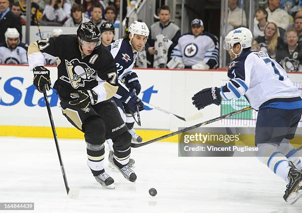 Evgeni Malkin of the Pittsburgh Penguins chases a loose puck against Derek Meech of the Winnipeg Jets in the third period on February 28, 2013 at the...