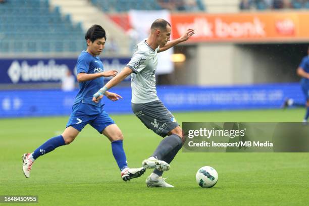 Hyunseok Hong of AA Gent battles for the ball with Radosav Petrovic of Apoel during the qualifying game/ Play Off between Kaa Gent and FC Apoel in...