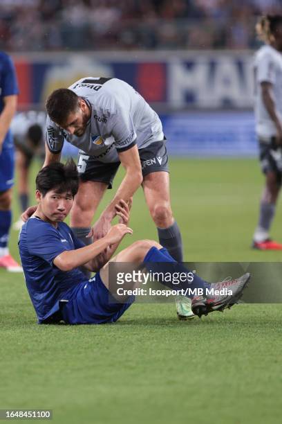 Lasha Dvali of Apoel helps Tsuyoshi Watanabe of AA Gent during the qualifying game/ Play Off between Kaa Gent and FC Apoel in Gent on the 24th of...