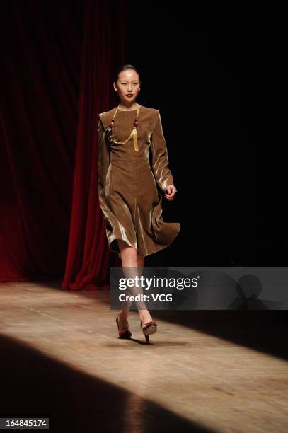 Model showcases designs on the catwalk during the Asahi Kasei Creativity Award Wang Yutao collection show on the fifth day of Mercedes-Benz China...