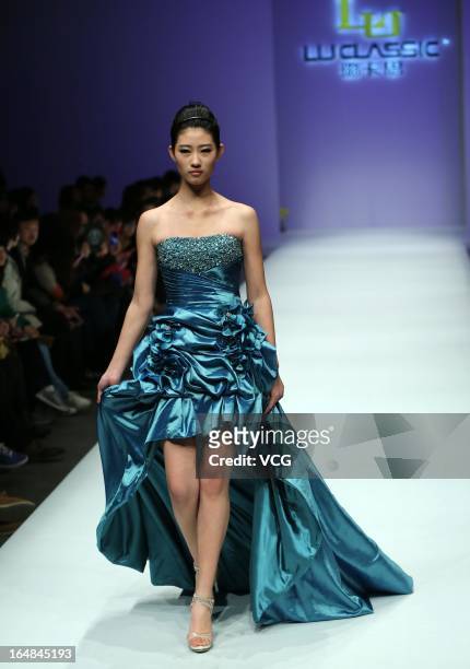 Model showcases designs on the catwalk during the LU Classic Lu Weixing Dress collection show on the fifth day of Mercedes-Benz China Fashion Week...