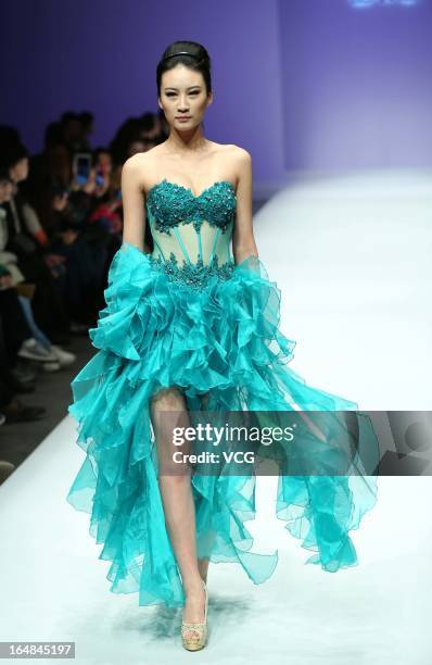 Model showcases designs on the catwalk during the LU Classic Lu Weixing Dress collection show on the fifth day of Mercedes-Benz China Fashion Week...