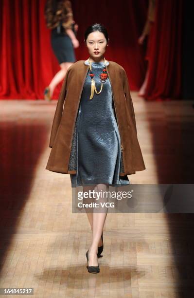 Model showcases designs on the catwalk during the Asahi Kasei Creativity Award Wang Yutao collection show on the fifth day of Mercedes-Benz China...