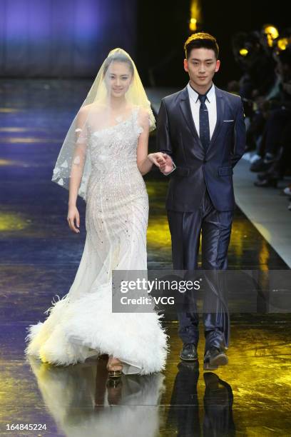 Models showcase designs on the catwalk during the MARK ALPHA OERMA Mark Cheung Wedding Dress collection show on the fifth day of Mercedes-Benz China...