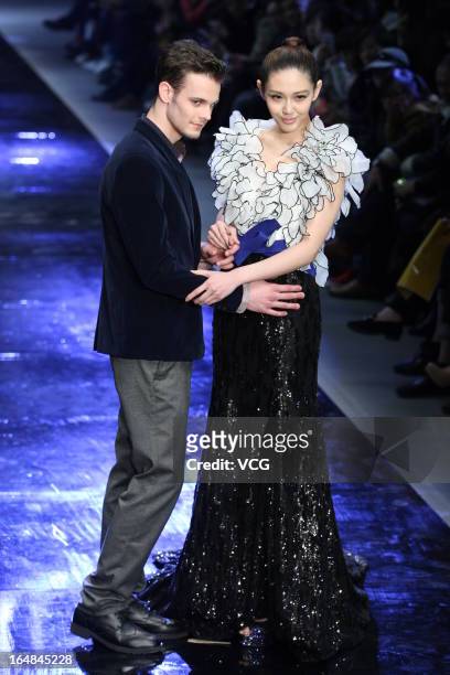 Models showcase designs on the catwalk during the MARK ALPHA OERMA Mark Cheung Wedding Dress collection show on the fifth day of Mercedes-Benz China...