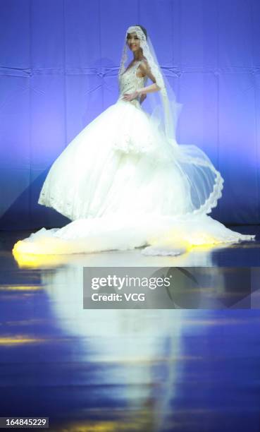 Model showcases designs on the catwalk during the MARK ALPHA OERMA Mark Cheung Wedding Dress collection show on the fifth day of Mercedes-Benz China...