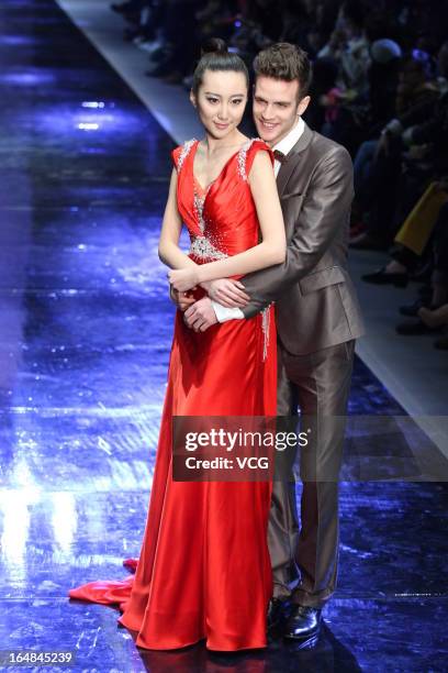 Models showcase designs on the catwalk during the MARK ALPHA OERMA Mark Cheung Wedding Dress collection show on the fifth day of Mercedes-Benz China...