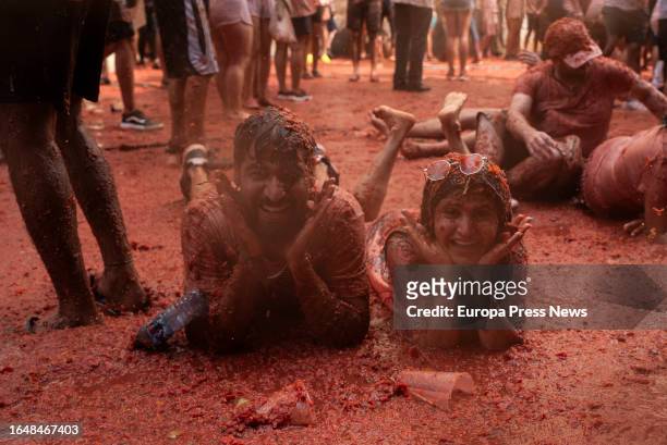 Two people covered with tomato during the festival of La Tomatina, on 30 August, 2023 in Buñol, Valencia, Valencian Community, Spain. La Tomatina has...