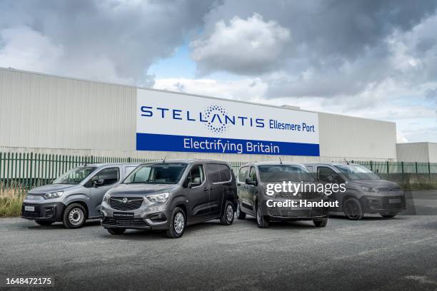 In this handout image provided by Stellantis, range of electric vans from Stellantis brands Peugeot, Citroen, Fiat and Vauxhall lined up outside the...