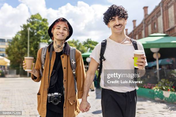 gay couple enjoying on holiday in foreign city - berlin mitte stock-fotos und bilder