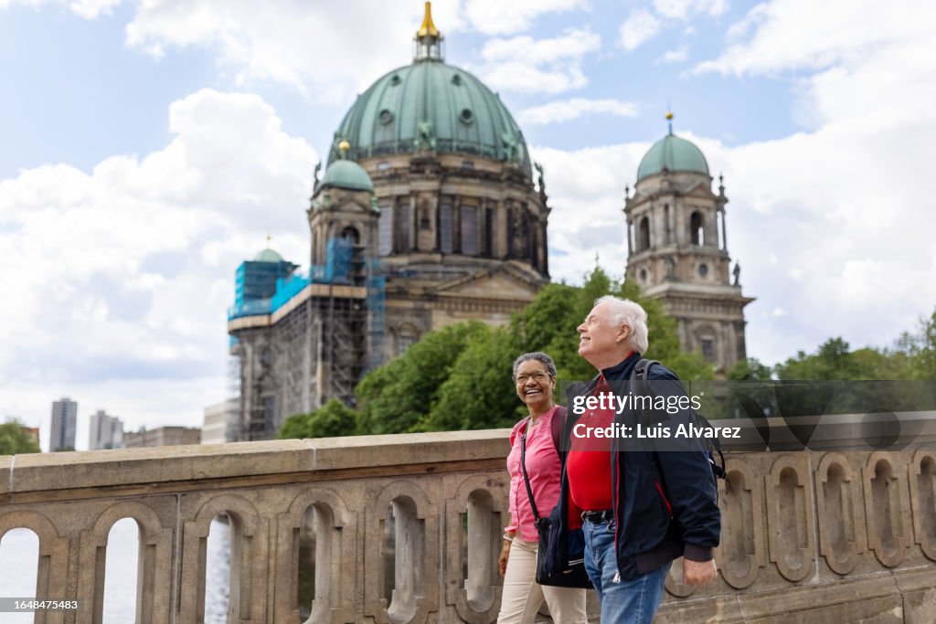 Smiling senior couple exploring Central Berlin on foot