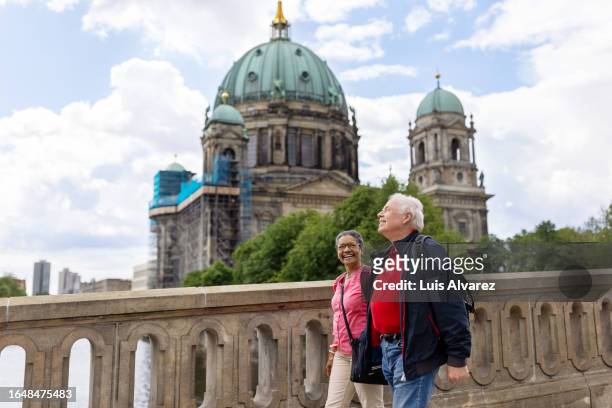 smiling senior couple exploring central berlin on foot - mitte stock pictures, royalty-free photos & images