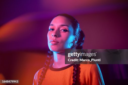 Young woman portrait under neon colored lights Young woman portrait under neon colored lights
