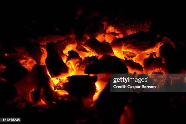 close-up of glowing embers - tizzone foto e immagini stock