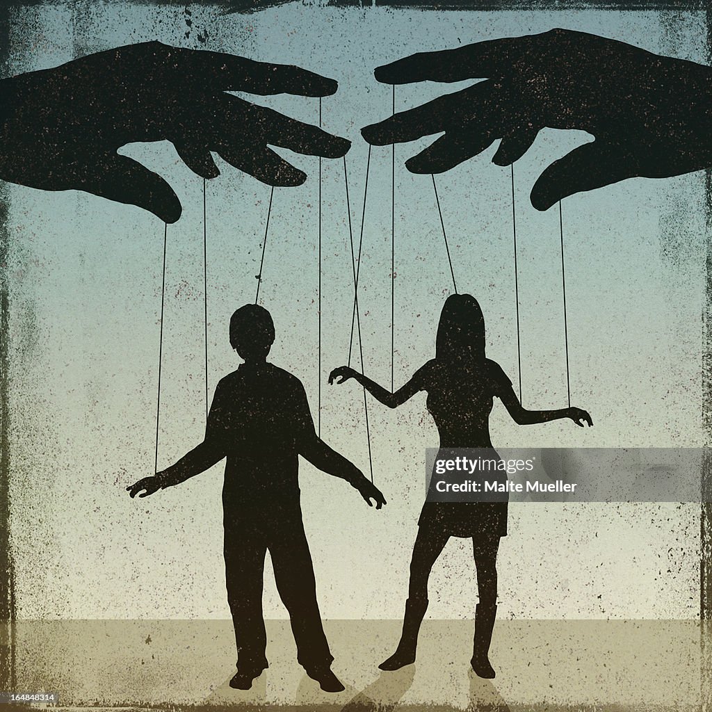 A silhouetted man and woman being controlled by a puppeteer