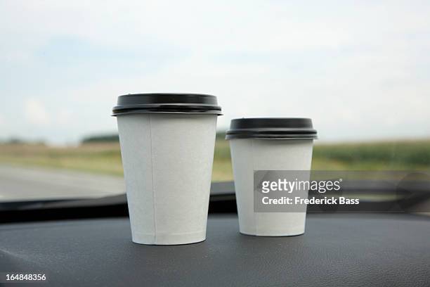 two disposable cups of coffee on a car dashboard - coffee cup takeaway stock pictures, royalty-free photos & images