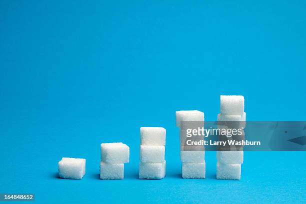 ascending stacks of sugar cubes - sugar stock pictures, royalty-free photos & images