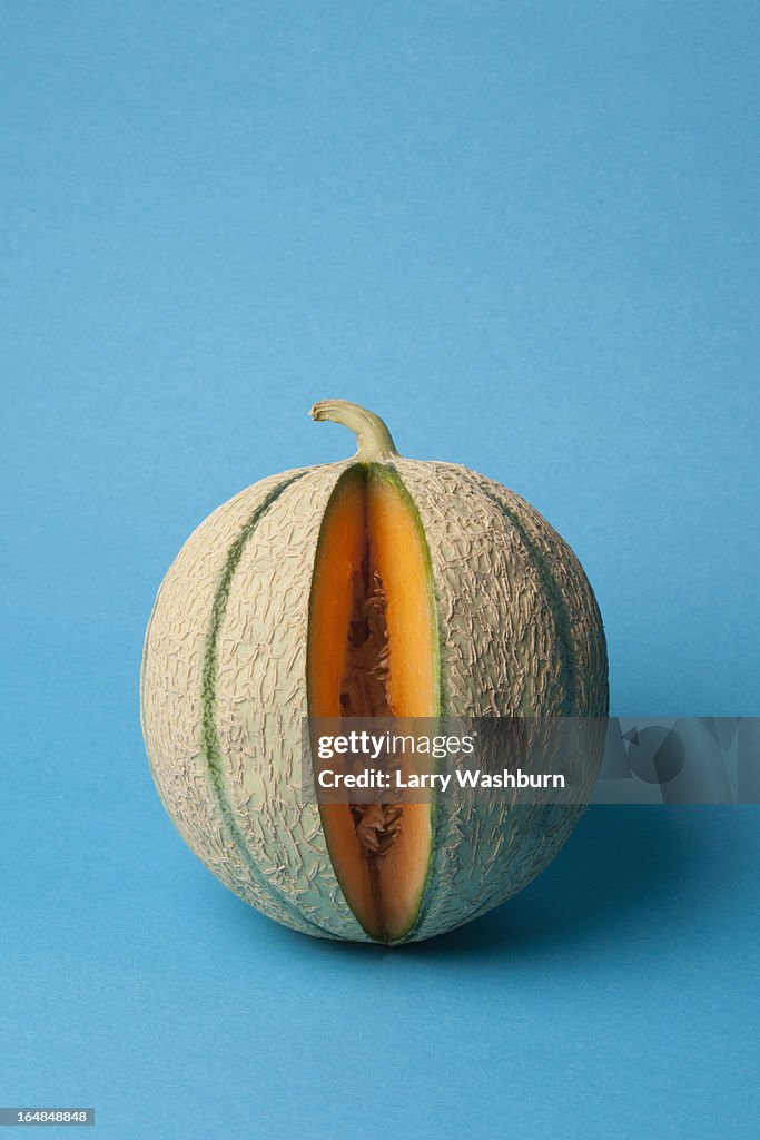 A cantaloupe with a slice removed