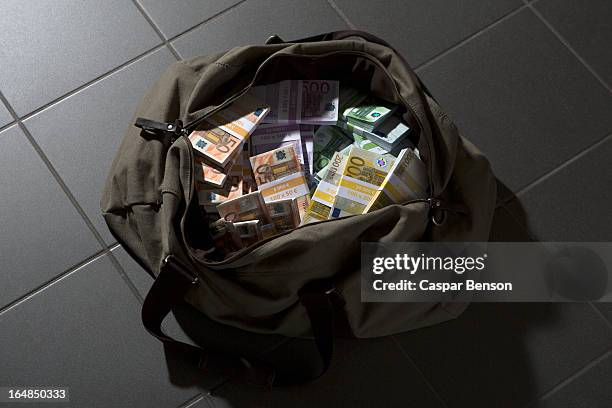 a bag full of large billed euro banknotes - sacco di soldi foto e immagini stock