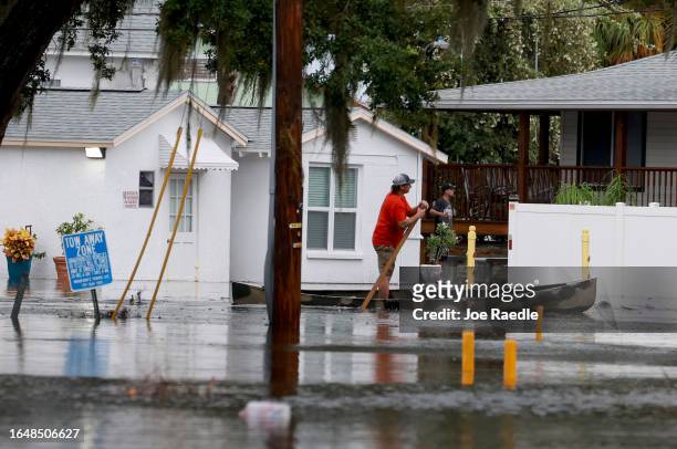 Person canoes through the flooded streets caused by Hurricane Idalia passing offshore on August 30, 2023 in Tarpon Springs, Florida. Hurricane Idalia...