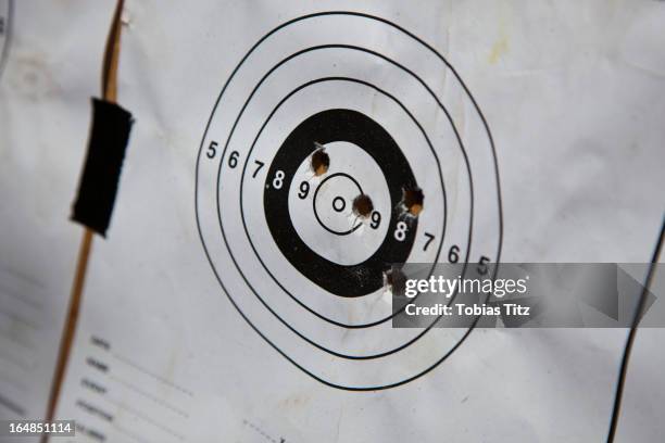 bullet holes on a paper target - off target stock pictures, royalty-free photos & images