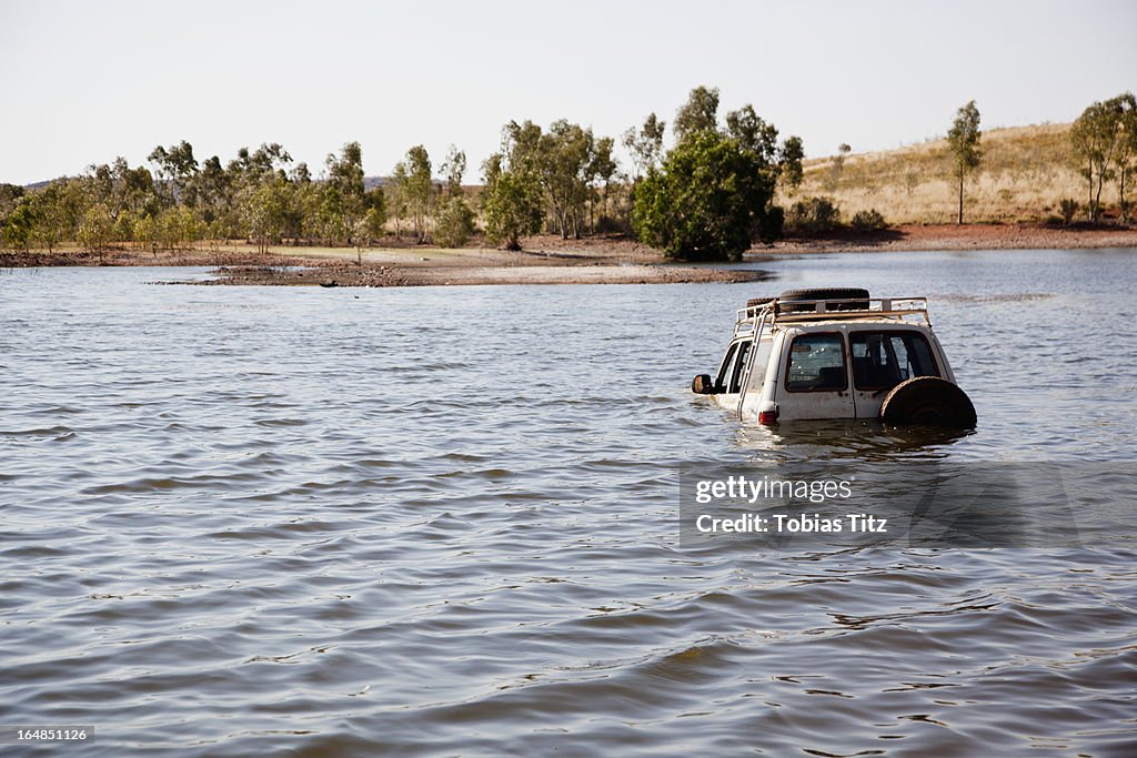 A 4x4 driving through deep water