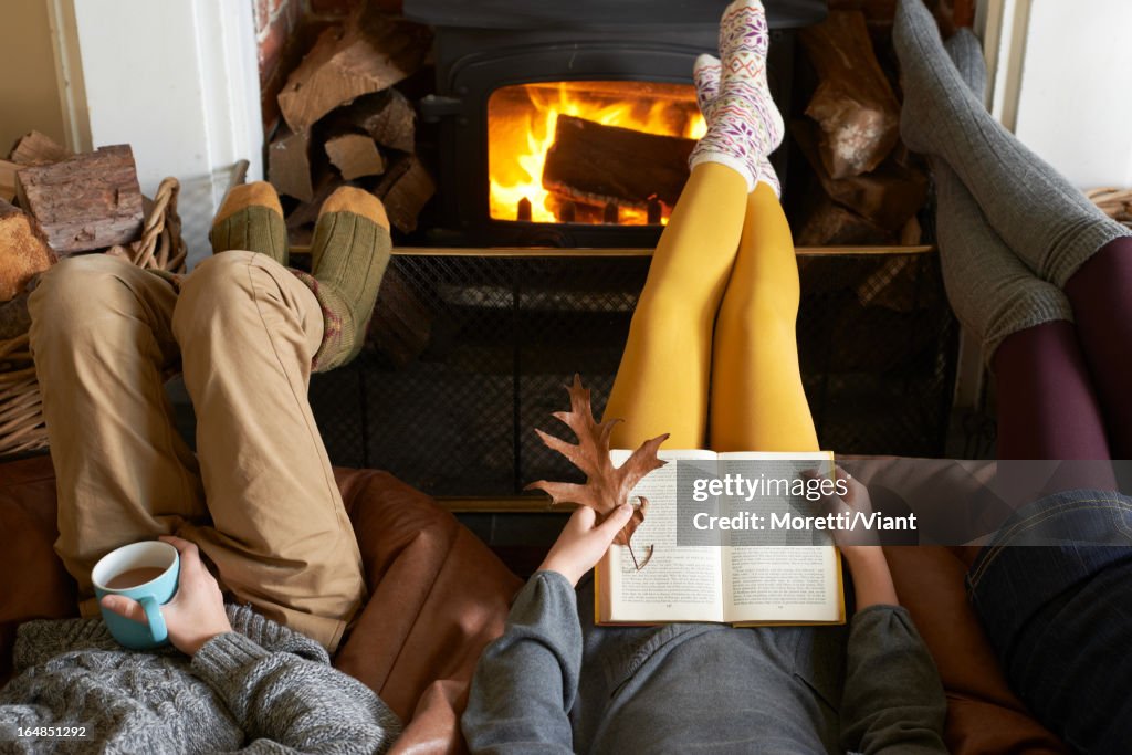 Children relaxing by fire