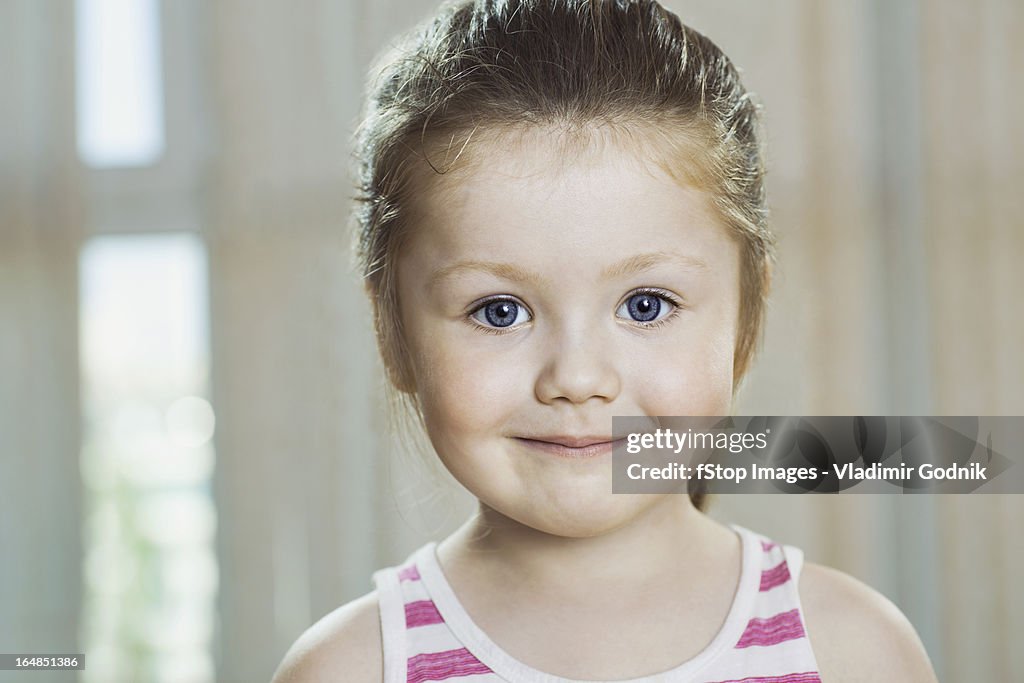A young girl smiling into the camera