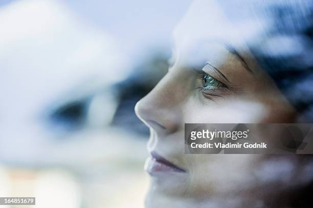 a young woman looking thoughtfully out the window of a stationary car - anticipation face stock pictures, royalty-free photos & images
