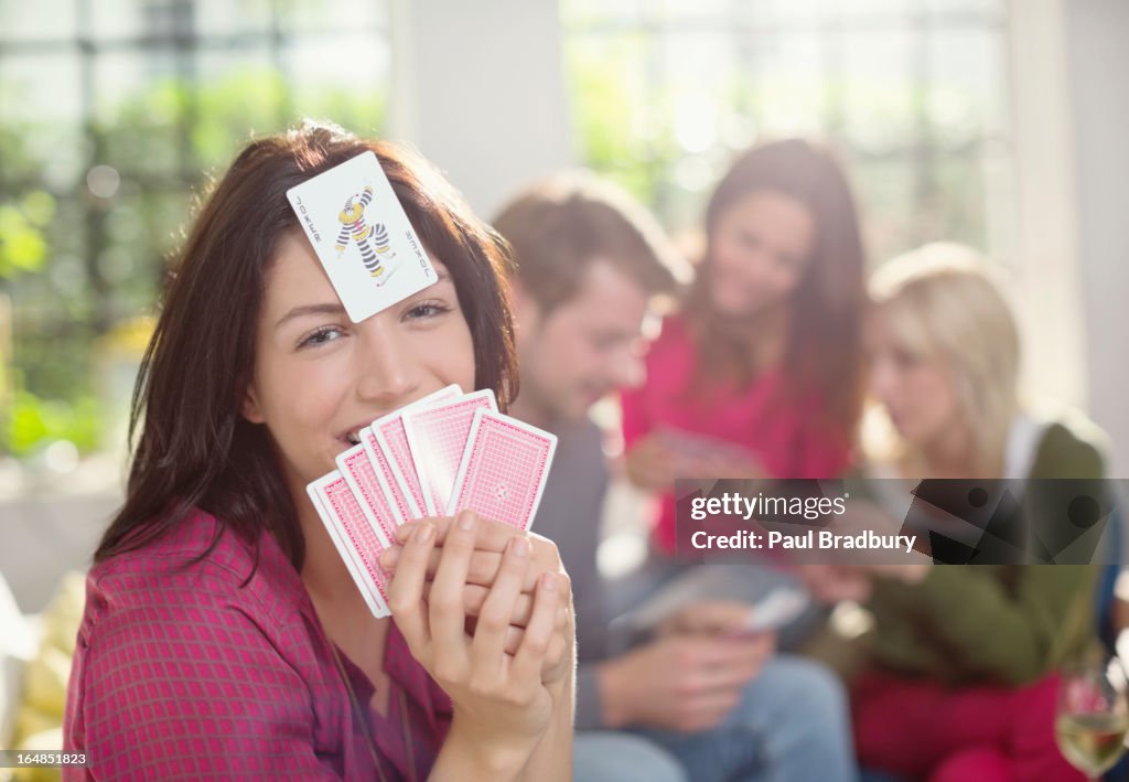 Smiling woman playing card game