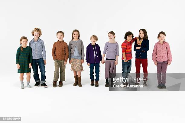 nine kids standing in a row - kids in a row stock pictures, royalty-free photos & images