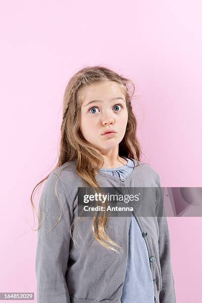 a girl with an expression of disbelief on her face - child shock studio stock pictures, royalty-free photos & images