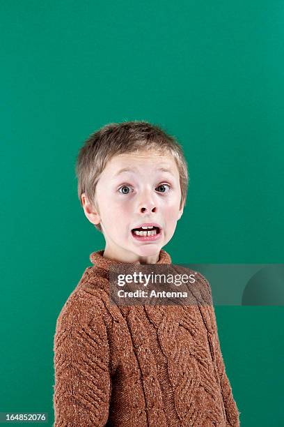 a boy with a shocked expression of fear on his face - child kid series expressions imagens e fotografias de stock