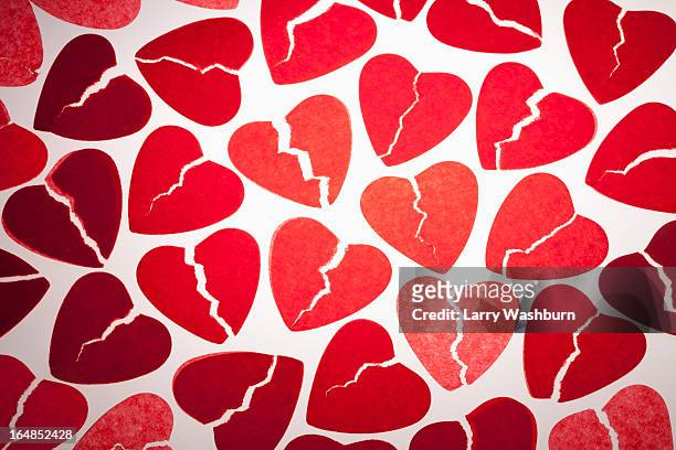a bunch of red tissue paper broken hearts - broken heart stockfoto's en -beelden