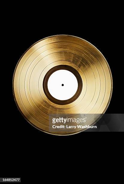 a gold record on a black background - vinyl records stock-fotos und bilder