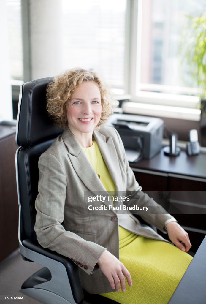 Businesswoman smiling at desk